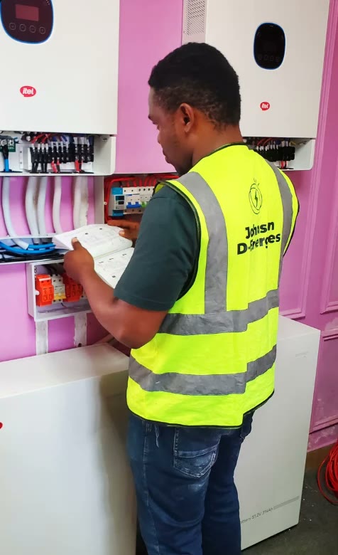 A technician checking a lithium battery and inverter installation